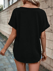 Black short sleeve t-shirt with decorative buttons and a V-neck, styled with denim shorts.