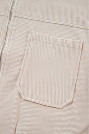 Cream corduroy bomber hoodie with a chest pocket and zipper detail.