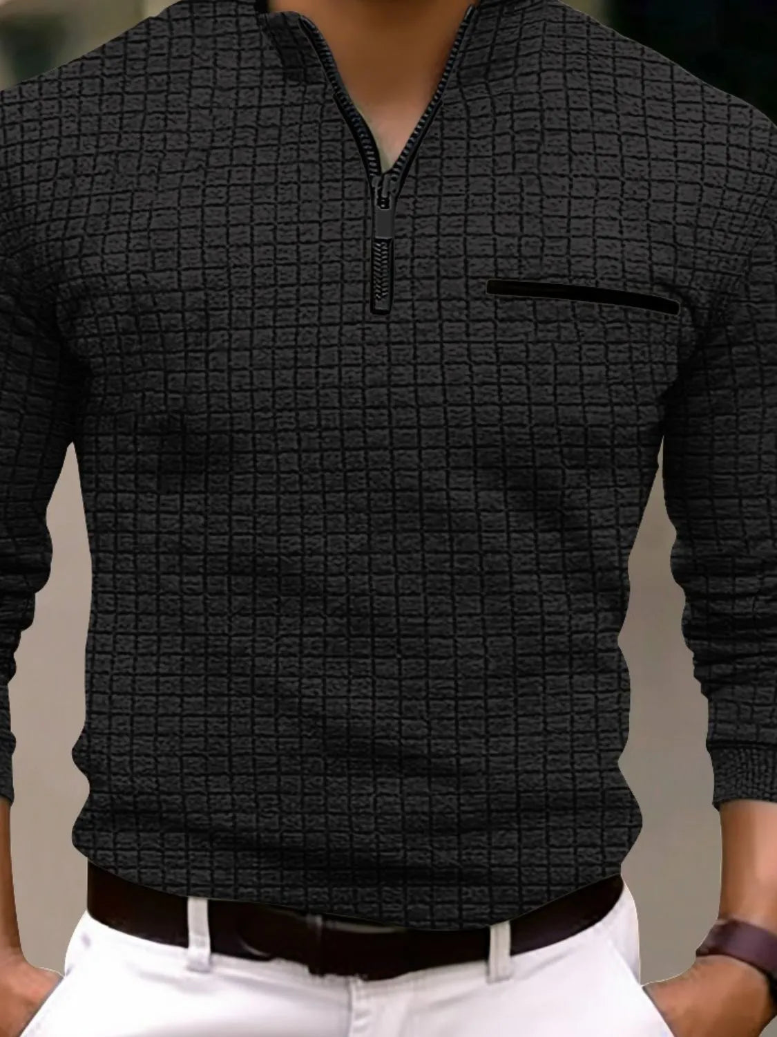 Black textured zip-neck polo with contrast pocket detail and long sleeves.