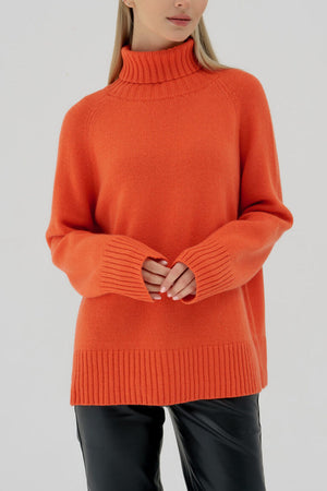 Orange cashmere turtleneck sweater with raglan sleeves and ribbed cuffs and hem.