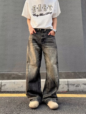 Men's vintage wash wide-leg jeans in relaxed fit, featuring distressed details and a faded black color.