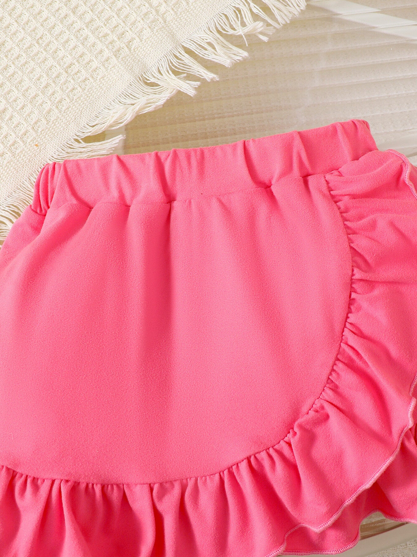 Bright pink ruffle skirt with elastic waist, part of a baby girls' set.
