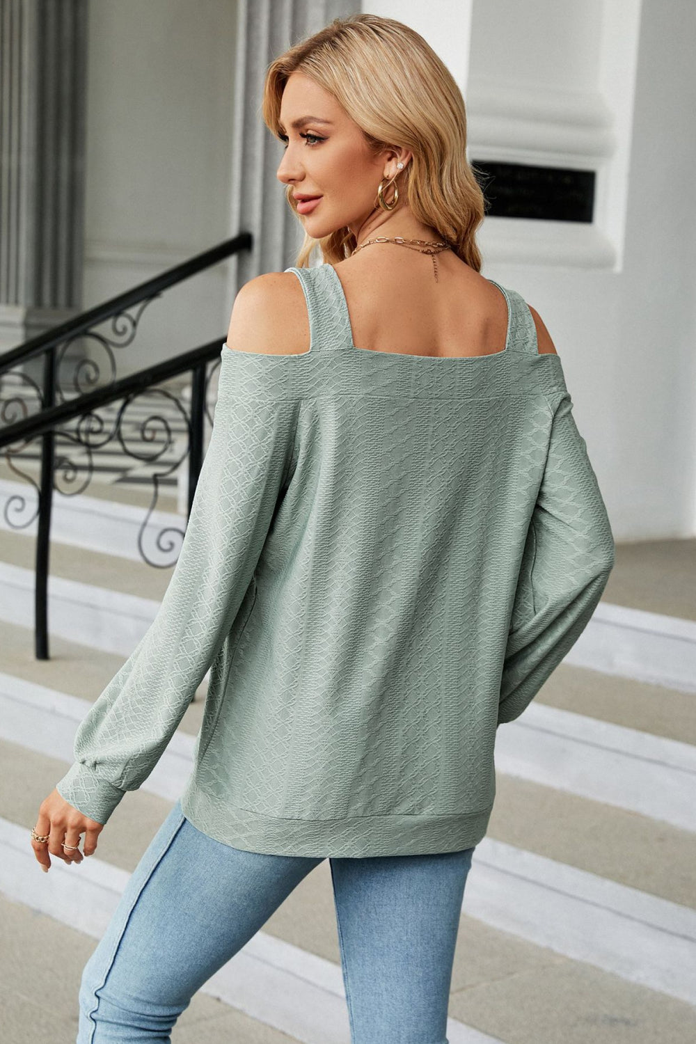 Sage open shoulder textured blouse with square neckline and long sleeves.