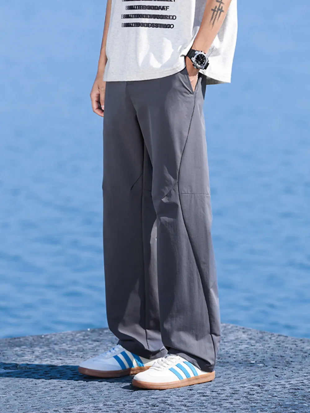 Men's dark gray relaxed fit lightweight joggers with pockets.
