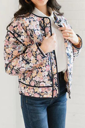 Floral quilted jacket with contrast piping and a spread collar.