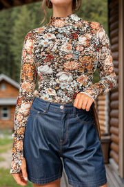Sheer floral second skin top with mock neck and long sleeves.