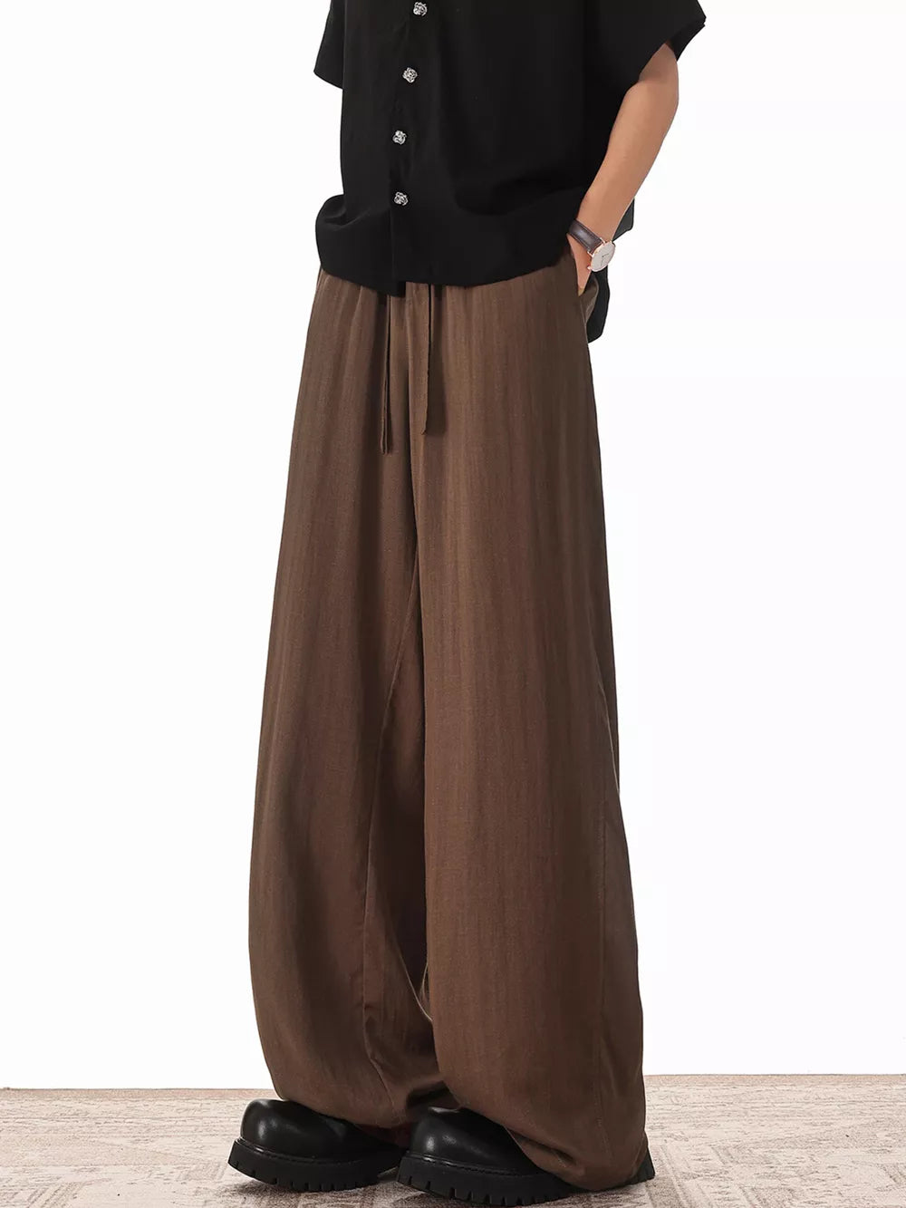 Brown relaxed fit drawstring sweatpants with a wide leg.