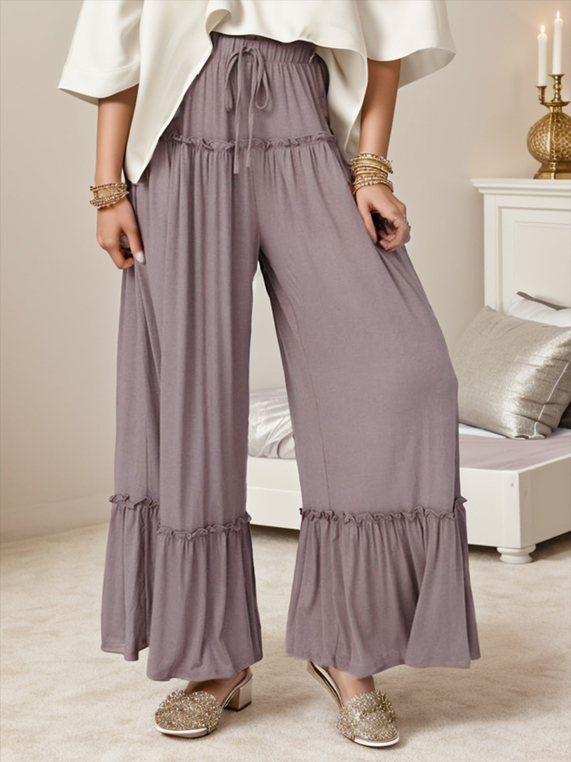 Mauve wide-leg pants with ruffle trim at the hem and drawstring waist.