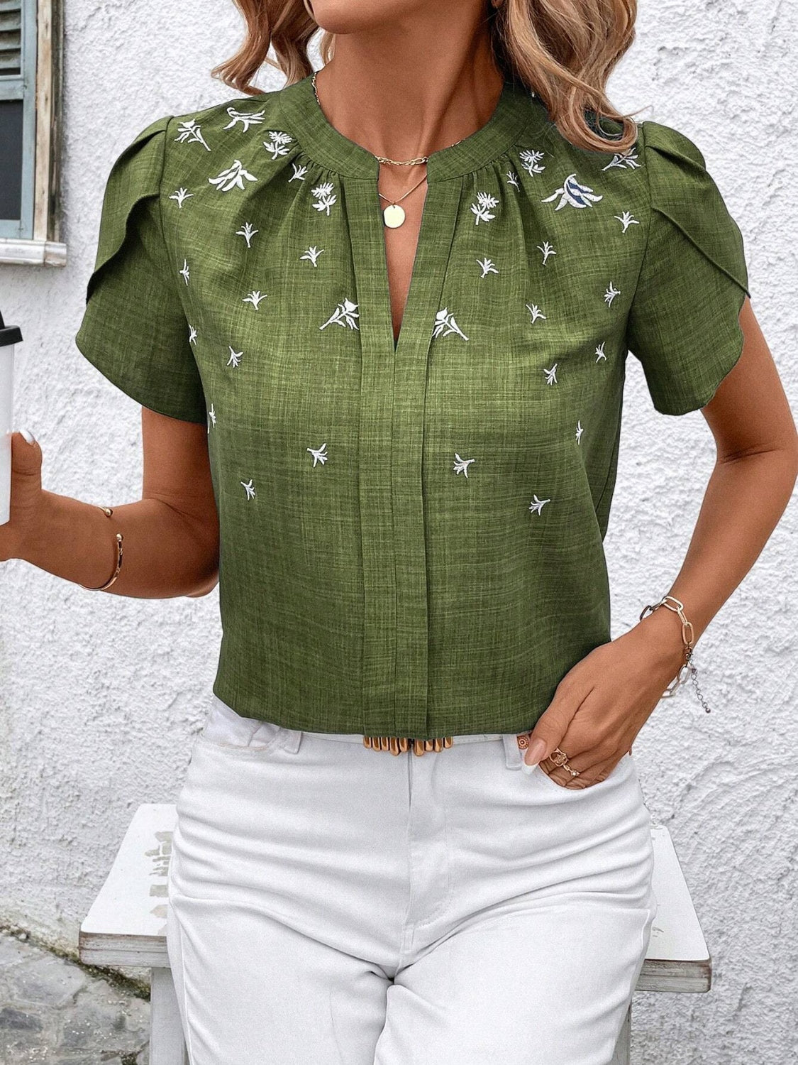Matcha green embroidered floral keyhole blouse with flutter sleeves.