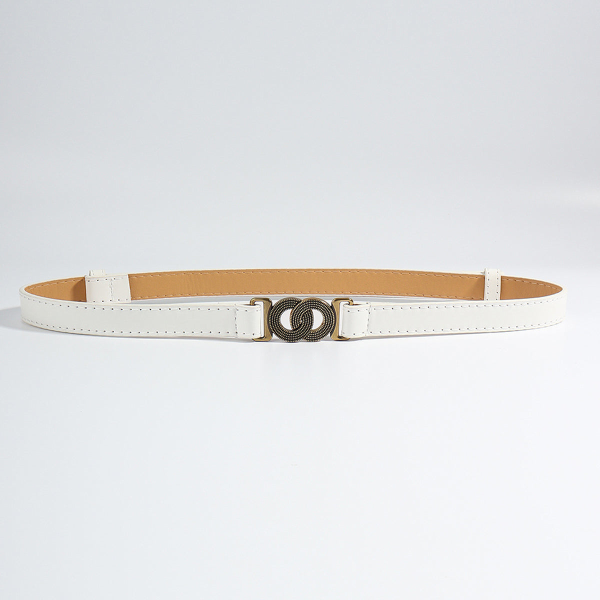 Ivory vegan leather belt with interlocking buckle and bronze hardware.