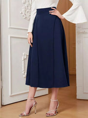 Elegant navy high-waisted midi skirt with a flared A-line cut, styled with a white bell-sleeve top.