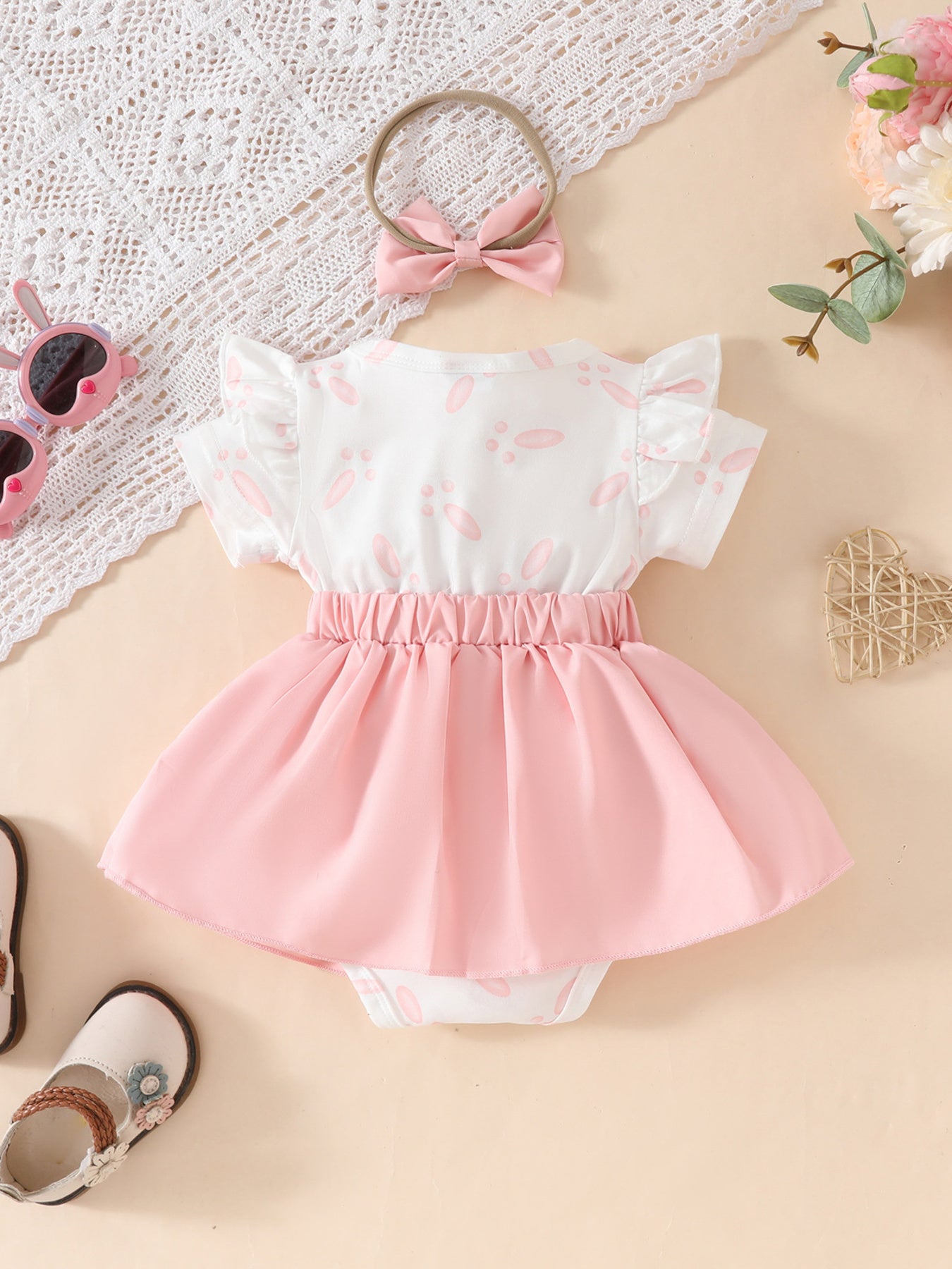 Baby dress set with pink bunny applique, ruffle sleeves, and pink skirt. Includes headband.