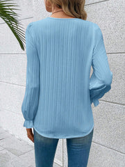 Sky blue textured pleat blouse with lace trim cuffs and long sleeves.
