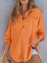 Orange waffle-knit Henley tee with button placket and chest pocket, long sleeves.