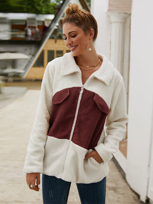 Colorblock shearling zip-up jacket with burgundy pockets and collar, featuring a relaxed fit.
