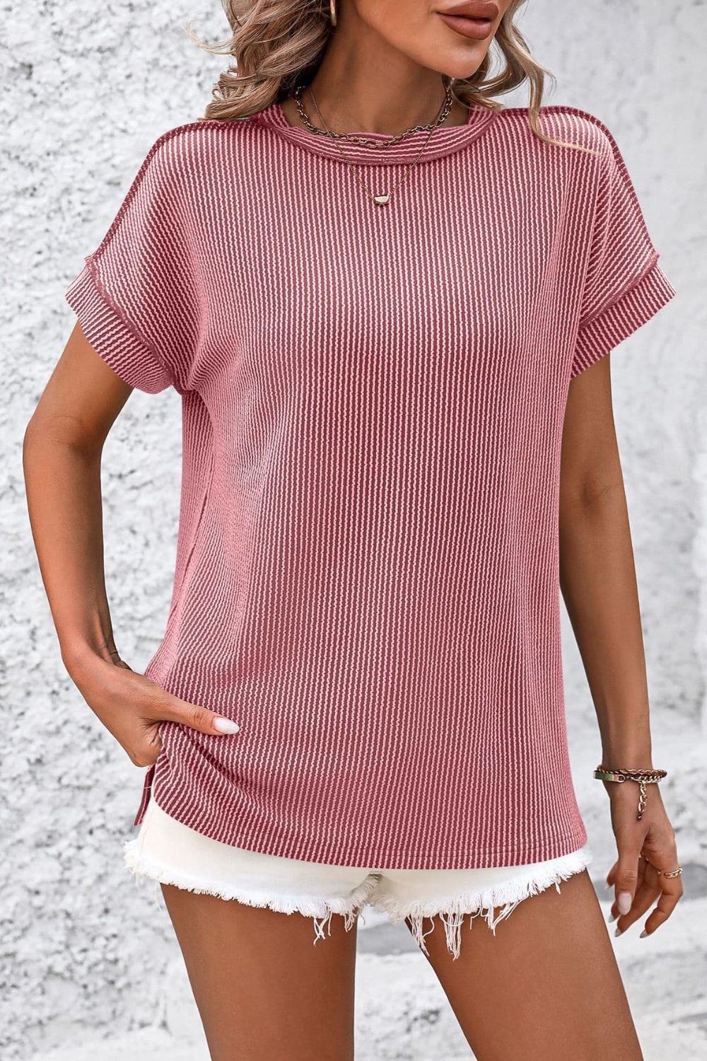 Deep Rose vertical ribbed tee with split hem and short sleeves.