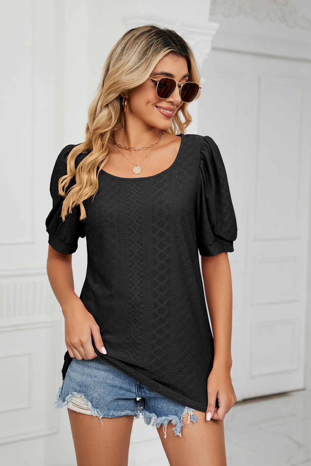 Black eyelet puff sleeve scoop neck blouse with textured pattern