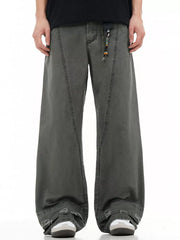 Men's wide-leg denim trousers in dark grey with distressed hem detail and beaded drawstring.