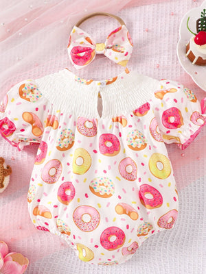 Baby smocked one-piece with donut print, puff sleeves, and matching headband.