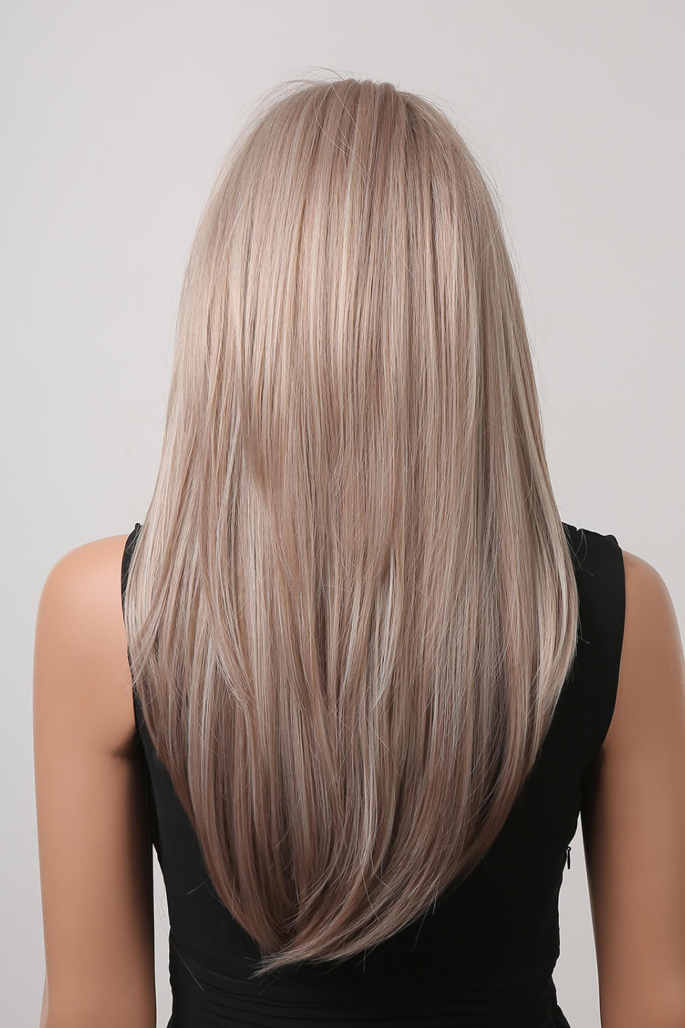 Layered synthetic wig in Blonde/Light Brown with subtle highlights, styled straight.