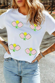 White cotton t-shirt with playful sequin pickleball applique detail.