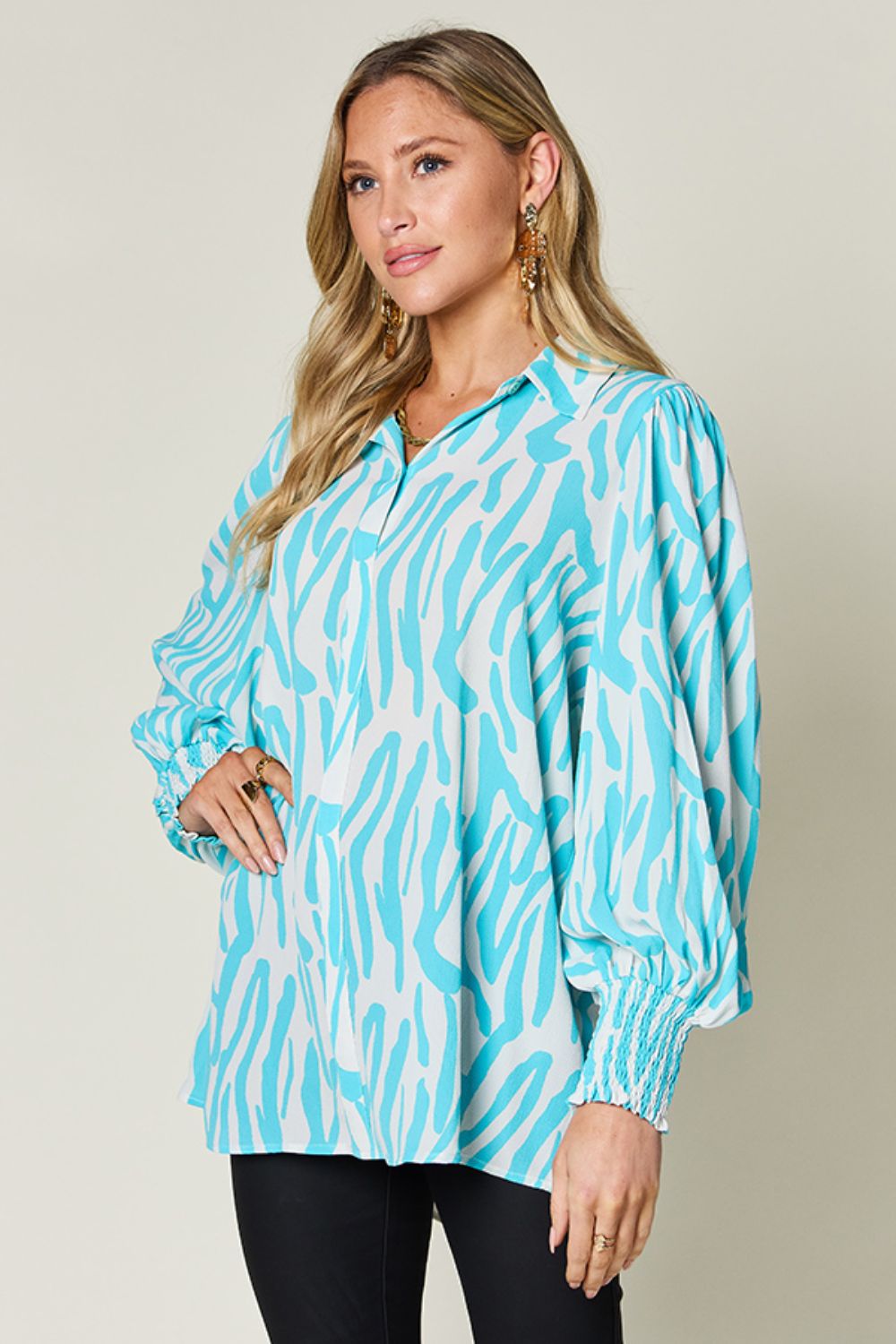 Blouse with zebra print, shirred cuffs, and balloon sleeves in Tiffany Blue.