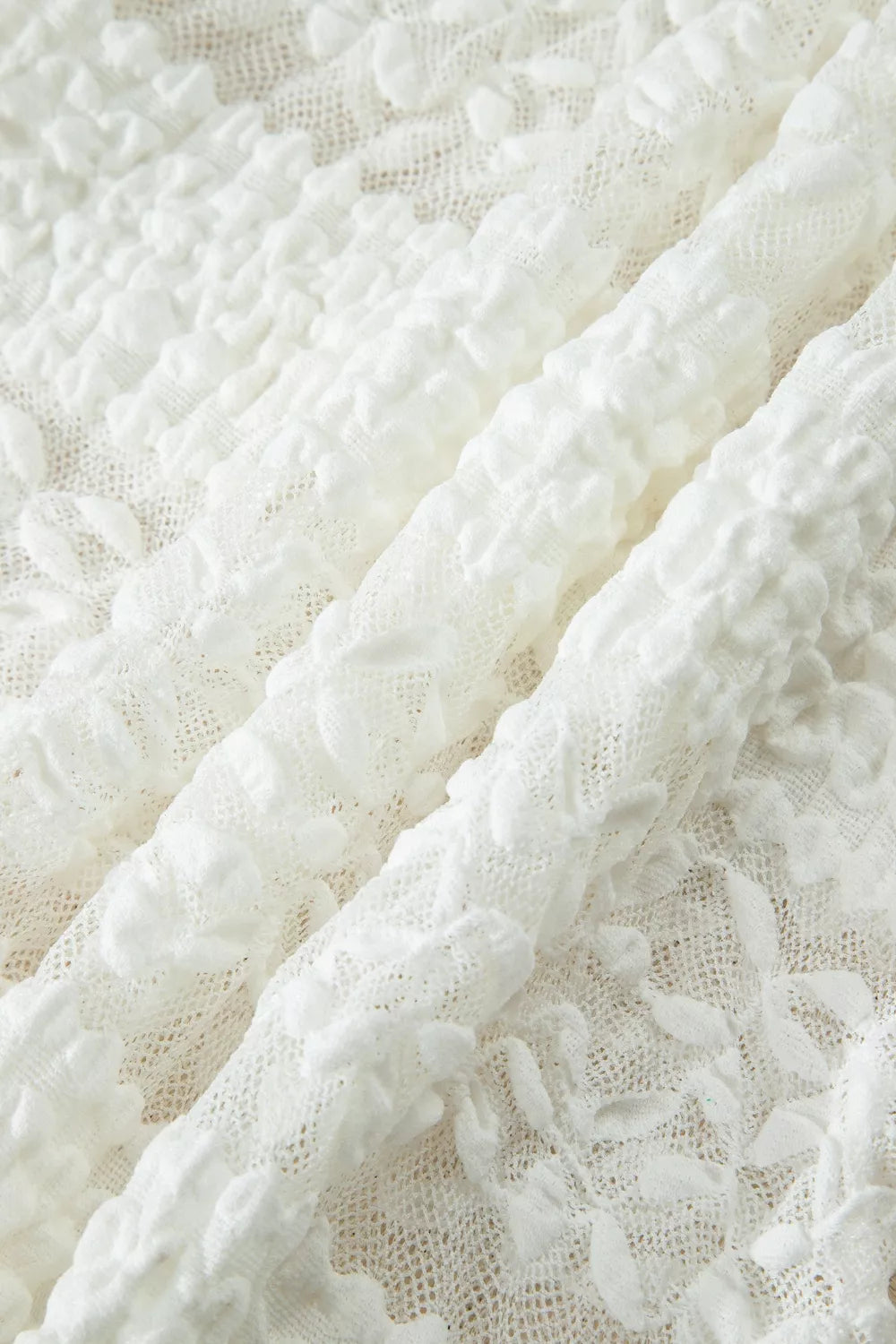 White lace patchwork sheer t-shirt with textured floral details.