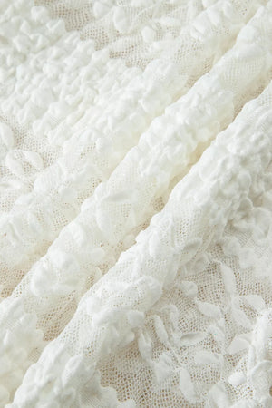 White lace patchwork sheer t-shirt with textured floral details.