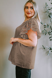 Mocha eyelet flutter sleeve tee with scalloped trim and breathable fabric.
