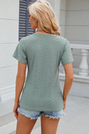 Light green eyelet wrap V-neck top with short sleeves and a casual cut.