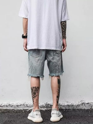 Men's distressed denim shorts in light blue with frayed hem and ripped details.
