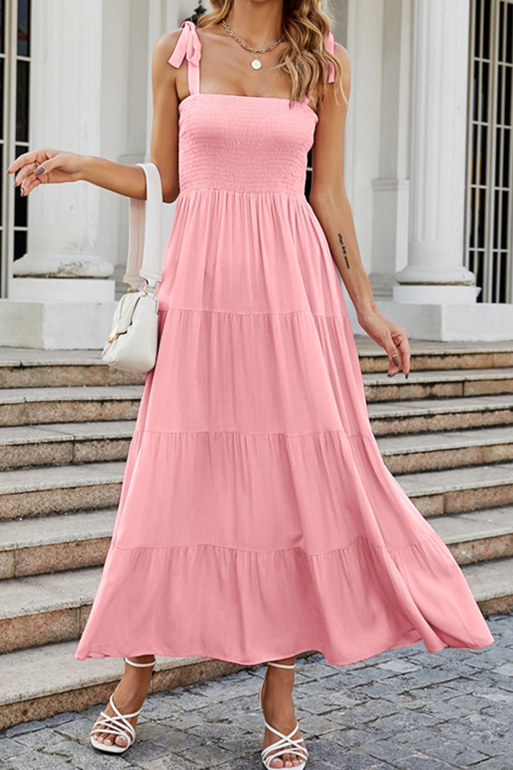 Blush pink tiered ruffle maxi dress with smocked bodice and tie straps.