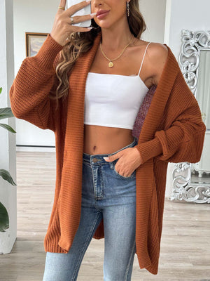 Ochre ribbed knit cardigan with pearl buttons, open front, long sleeves.