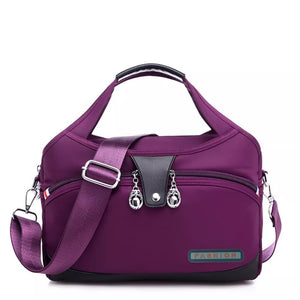 Spacious purple nylon tote bag with decorative charms and a "FASHION" patch.