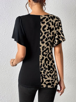 Black and leopard print asymmetric paneled top with short sleeves.