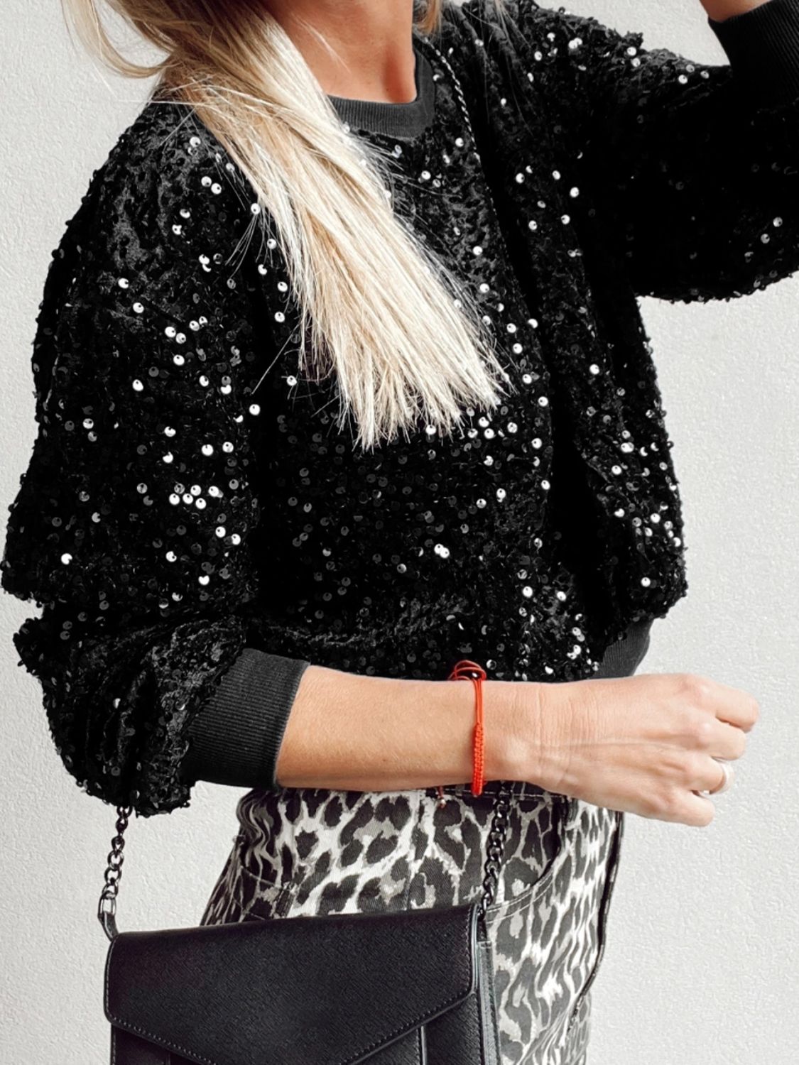 Black sequin embellished sweatshirt with ribbed cuffs and crew neck.