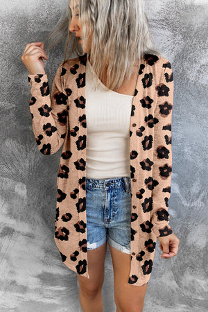 Leopard print open-front duster cardigan in tan with button details, worn casually over a tank top and denim shorts.