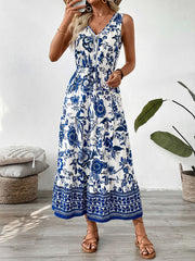 Charming floral midi dress with drawstring waist, V-neck, sleeveless, tiered hem, blue and white pattern.