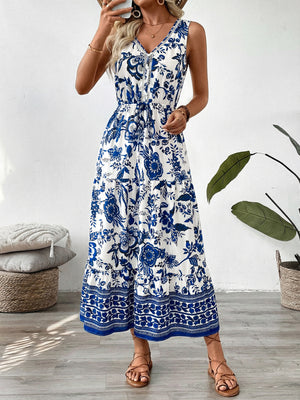 Charming floral midi dress with drawstring waist, V-neck, sleeveless, tiered hem, blue and white pattern.