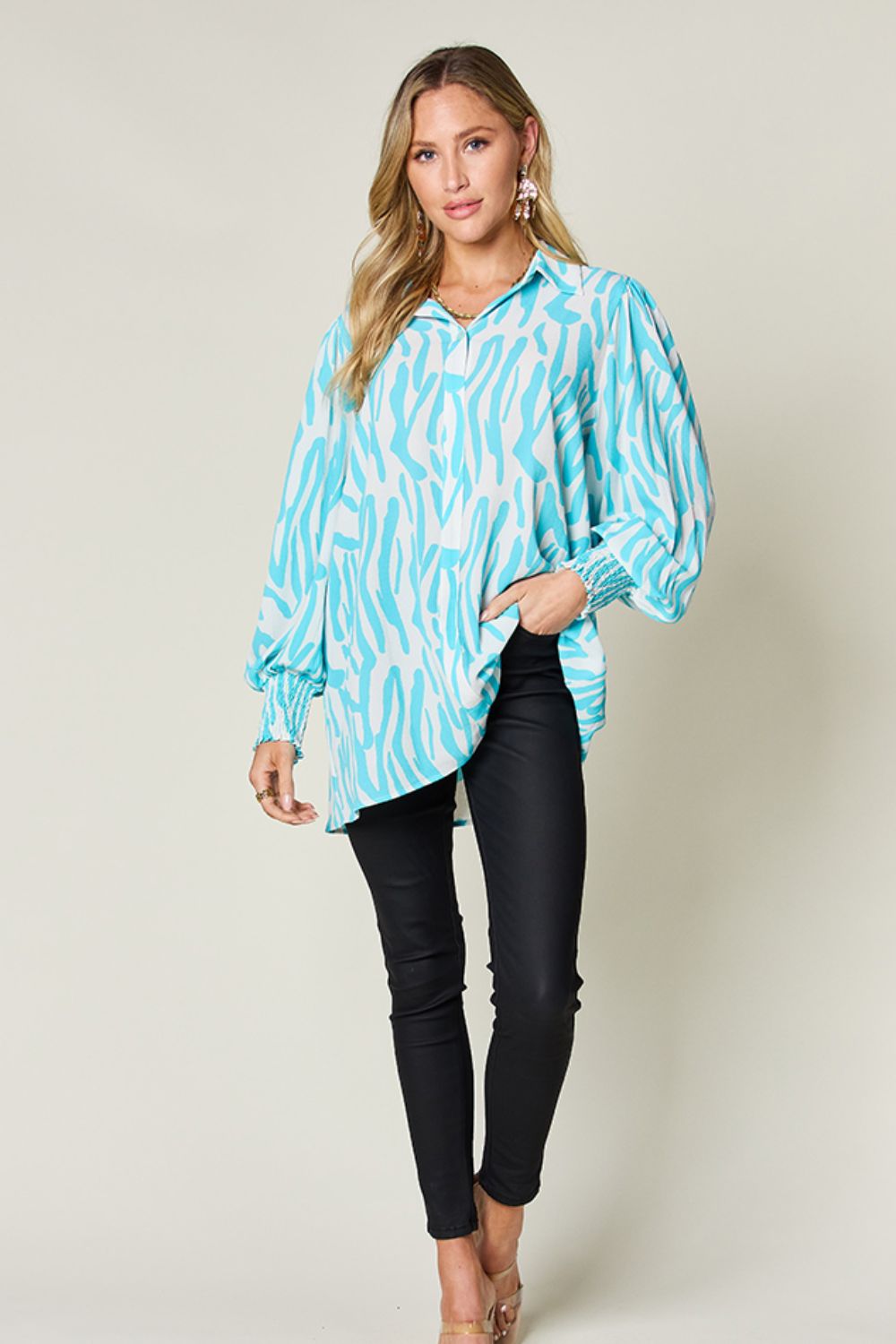 Tiffany blue zebra print blouse with shirred cuffs and a collared neckline.