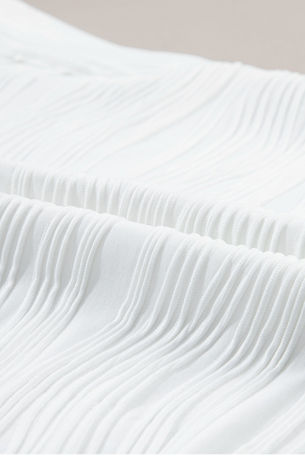White textured wave cap-sleeve mock neck top detail