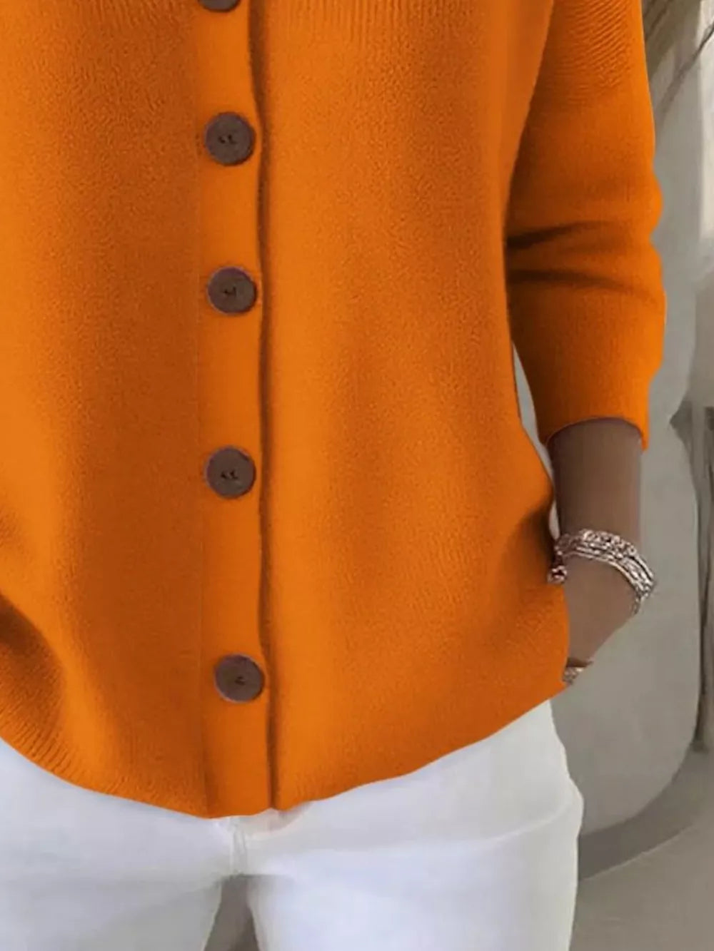 Orange button-front knit cardigan with brown buttons, casual acrylic material.