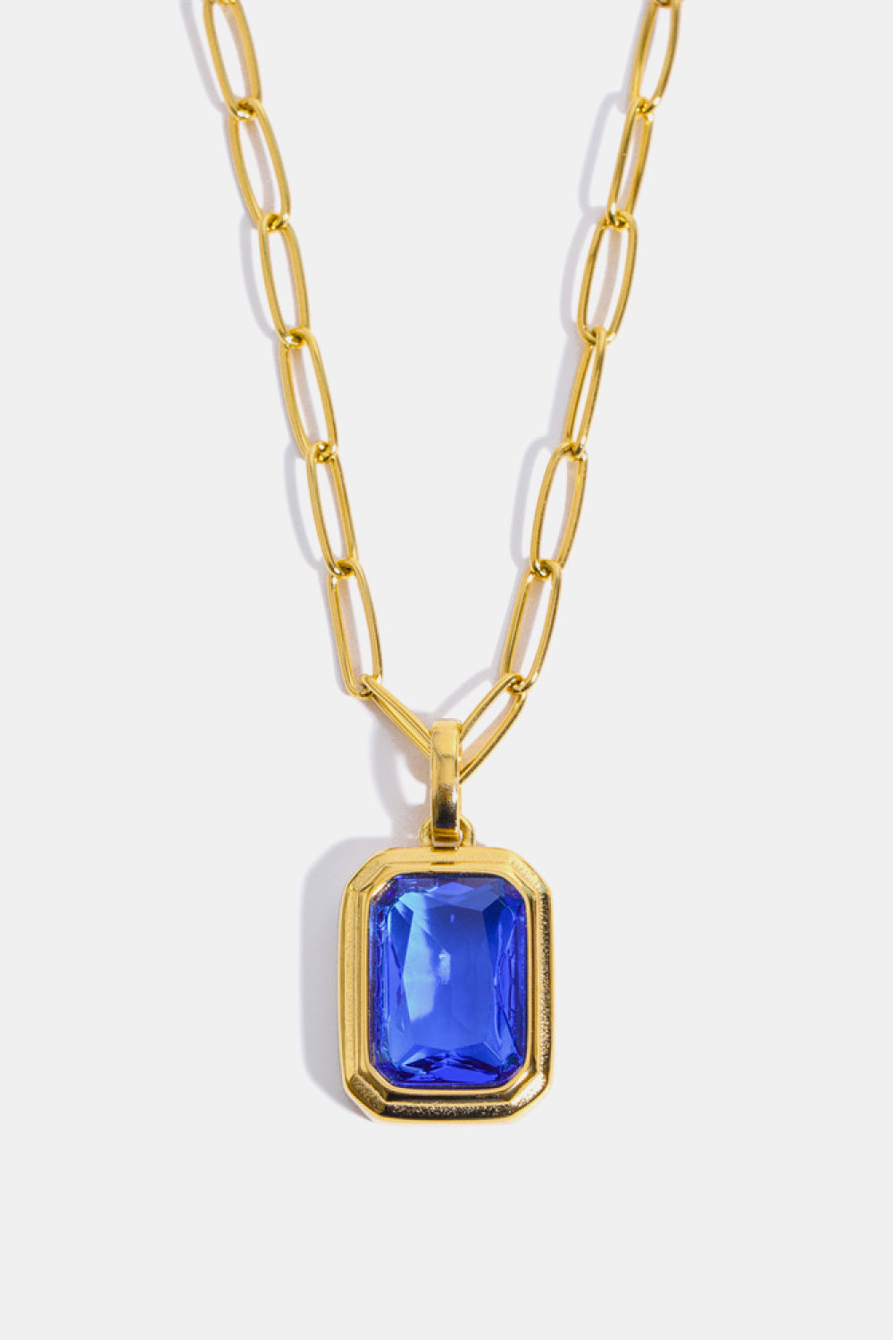 Gilded Prism pendant necklace with royal blue gemstone and 18K gold chain.