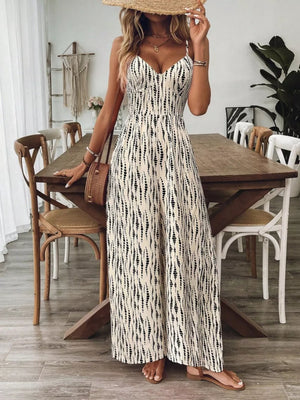 Cream and black abstract print wide-leg jumpsuit with V-neck and spaghetti straps.