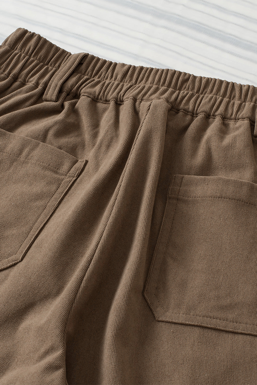 Seamed front wide leg trousers in caramel with elastic waistband and back pockets.