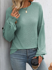 Sage ribbed knit blouse with ruffled cuffs and crew neck.