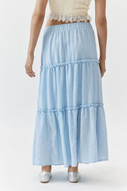 Tiered cotton maxi skirt in light blue with ruffled tiers and an elastic waistband.