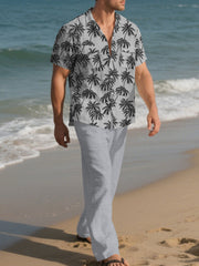 Men's gray relaxed fit pants with a subtle texture, styled on a beach.