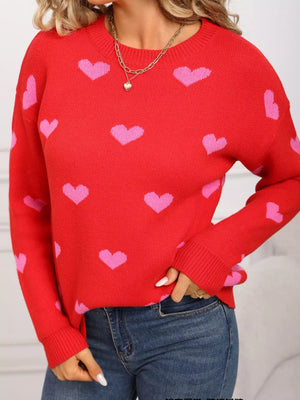 Red acrylic sweater with pink hearts, crew neck, long sleeves, and ribbed cuffs.