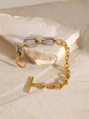 Two-tone chain link bracelet with toggle clasp and gold accent ring.